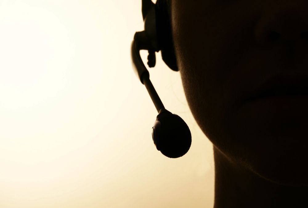 close up of call center agent and microphone