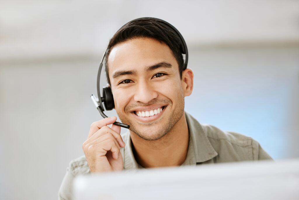 man smiling while wearing a headset